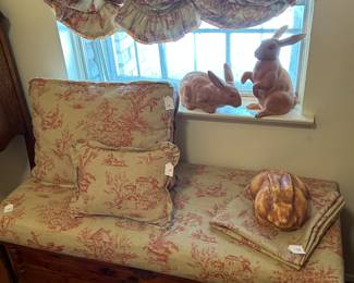 Gorgeous cedar chest with hand sewn cushion & throw pillows. Collection of bunny figurines.
