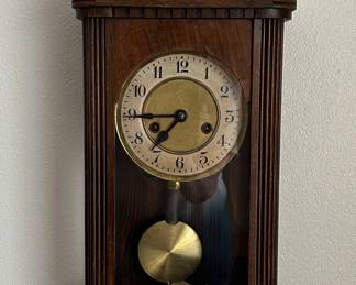 Antique striking wall clock with key