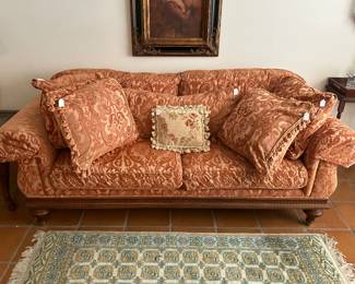 Vintage rolled arm sofa with an array of throw pillows 
