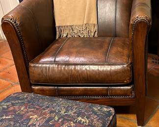 Leather club chair with brass studs.