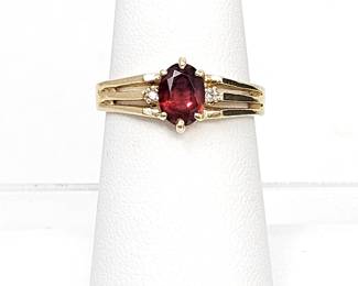 Lovely 14k Yellow Gold Ring with a Faceted Oval Garnet Center Stone and Two Diamond Accents - Size 6.5