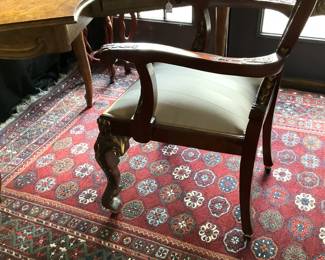 One of two arm chairs with ornate carving (from the Lou Ornelas estate); hand-woven rug - 5 feet x 8 feet