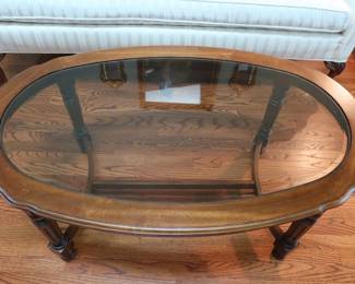 oval  beveled glass  top  coffee  table.   The  size  is  48"  x  28"