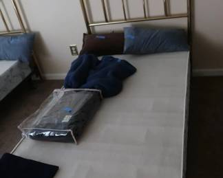 One  of  two  twin  size  brass  headboards and bed frames.  There  is  one  twin  box spring.