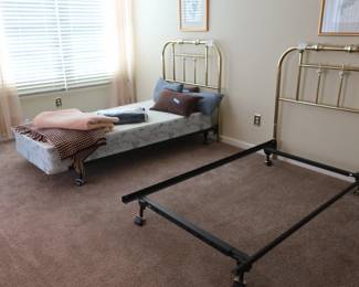 another  view  of  bedroom  with  brass  headboard twin  bed frames   There  is  one  box  spring for a  twin  bed.