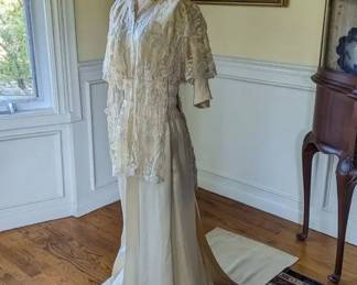 11.)  ca 1910's Bridal/Wedding/Evening dress, Princess lace on machine made netting, faux pearls, embroidery.  Front snap closure, Trained edged with faux pearls - a few missing.  Bottom of skirt and train soiled.  Otherwise, excellent condition.   Measures:  shoulder to shoulder -  14", Bust 28",  Waist 22",  Length 54",  Length with Train - 72".    $550.00  Sale:  $412.00