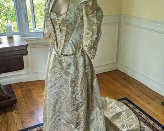 4.)  19th century Ivory Brocade gown with metallic embroidery.  Labeled Arnold Constable & Co. NY. 1 piece gown made to look like 2 pieces.  Bodice is boned.  Hook and eye closure.  Train.  Inner ties for bustle.  Museum de-accession.  Stitching at skirt has come out at waist and needs to be redone to make skirt fit.  Otherwise, Excellent condition.  Measures:  Shoulder to shoulder 12:, Bust 26", Waist 22", Length 51".  $1200.00  Sale:  $899.00