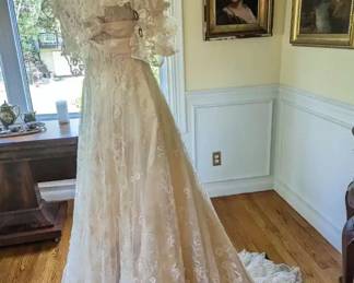 1.)  Antique Brussels Lace Bridal/Wedding gown.  Lace is in excellent condition aside from one small tear in the netting.  Boned bodice, wires in the collar to keep it standing.  Hook and eye closure in back. Inner silk is shattering.  Some underarm stains - mainly on lining.  Train.  Measures:  shoulder to shoulder - 14", Bust 33", Waist - 27", Length - 57".    $1800.00  Sale:  $1350.00