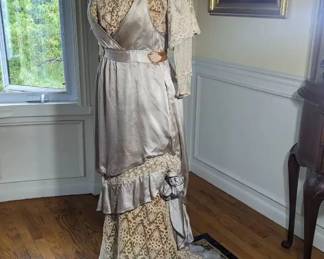 15.)  ca 1900's Edwardian lavender gown with lace and train.  Dress in in excellent condition except for some staining on  the lavender silk of the bodice.  It appears to have come from the background silks. Measures:  shoulder to shoulder 14",  Bust 35",  Waist - 27",  Length - 58"     $625.00  Sale:  $468.00