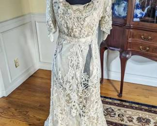 26.)  Ca 1900's Belgian Tape Lace Evening  Gown with Beading, Labeled.  Stunning tape lace gown with glass beading and embroidery.  Labeled "Kate Ker Lane, Victoria House, 1 Kensington High St. W".  Gown has train,  Inner lining is shattering.   Minor repair needed to lace.   Measures:  Shoulder to shoulder - 15",  Bust - 30",  Waist - 26", Length - 56",  Length with train - 68".   $750.00  Sale:  $525.00
