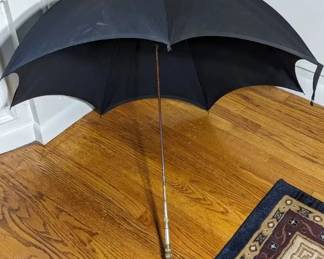 1.)  Black Parasol/Umbrella with Brass and Mother of Pearl Handle.  Handle is engraved Ethel.  1 small slit in top of material.   $138.00  Sale:   $96.00
