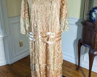 34.)  ca 1910 - 1920's Lace and satin Dress.  Large size. Beautiful pleating on bottom of the satin. Satin ribbons around drop waist.  Satin Rosettes on each side.  1 Small tear in satin ribbon in front. Near mint condition.  Measurements:  shoulder to shoulder 16",  Drop Waist - 38",  Length - 52". $1200.00  Sale:  $840.00
