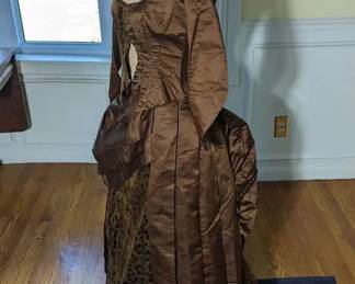 32.)  ca 1880's Brown Satin and Cut Velvet Bustle Gown with bustle cage.  Labeled Mrs W H Coffin, Rochester N.Y.  Bodice is boned and buttons down the front.  Has caged bustle for the bustle.  There is 1 small tear at the collar.   Dress is in excellent, near mint condition.  Measurements:  Shoulder to Shoulder - 10",  Bust - 26",  Waist 20", Length 17".   Skirt:  Waist 22 ", Length 38", Total length - 55". $985.00  Sale:  $738.00