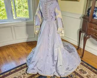 29.)  ca 1868 Lavender Bridal/Wedding gown with history. Valencieness Lace and fine thread Cluny Lace.  Dress has family note with it stating it is a wedding gown from 1868.   Drop shoulders, decorative braiding.  Original belt.  There are a few pin holes in  the skirt and some discoloration at underarms.  Occasional small stain.  Some dirt on train.  There are 4 missing buttons.  Some slight discoloration. Measures:  shoulder to shoulder - 17 ", Bust - 32", Waist 24", Length - 55",  Length with train - 80".   $725.00  Sale:  $580.00
