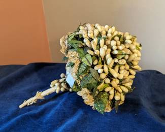 9.) Ca late 1800's Wax Bridal/Wedding Bouquet.  Bouquet is wax orange blossom buds with green leaves, trimmed in lace.  Wire stems are wrapped in paper.  One side is a little flat from having been laid on.  I believe it can easily be reshaped.  Measures:  15" tall x 10" wide.  Excellent condition.  $235.00