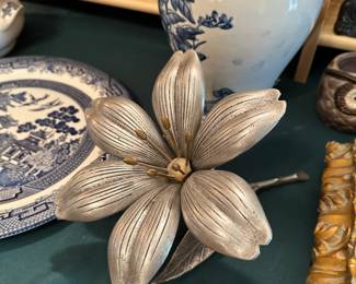 OK, this is super cool. It's been attributed to S. Agudo but ours is marked "patent pending" and it's a MCM ashtray where you pull the petals out for your cigarettes.