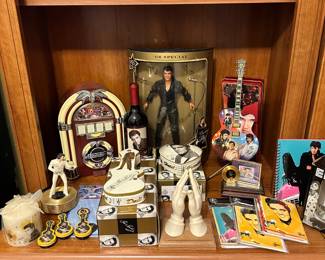 Elvis Shrine. He may have left the building but he is forever in our hearts. The little juke box radio works well and the Bradford Exchange Guitar lights up.