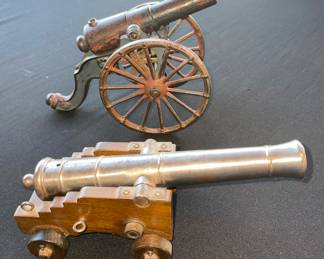 Vintage black powder cannon brass on wood stand and cast iron toy cannon