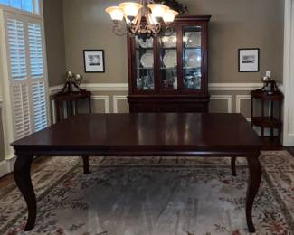 Dining room table; corner shelving from Havertys; china cabinet with sliding doors; area rug