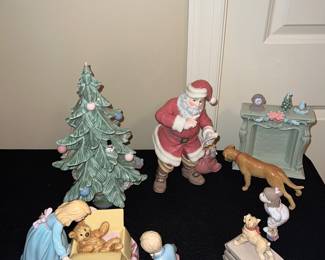 Ceramic figurines: mom with teddy; dad kneeling; pup on stack of dog food; little girl gazing; dog; fireplace; Santa with bag of toys
