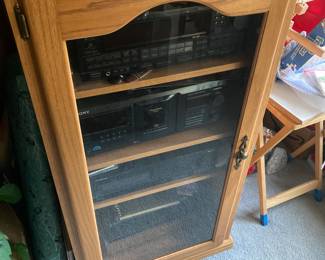 Four unit stereo system in specially made cabinet. There’s also two speakers.
