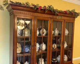 Stately china cabinet, filled with collectible teapots