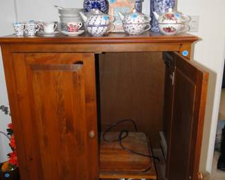Teapots, that are cups, and a very nice entertainment cabinet too