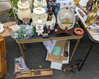 Crocks, native American female doll, Pink Floyd the wall on VHS, giant glass whisky barrel, steel wheel, brass pineapple, cast iron 3 lid set