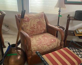 Easy rattan chair with red/ caramel upholstery --- small metal bench with pillow --- decorative lamp
