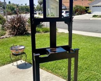 Dark wood hall tree with mirror and small covered shelf