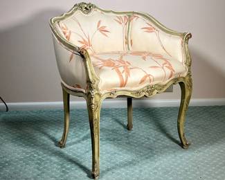 FRENCH CARVED SLIPPER ARMCHAIR | Carved wood frame with curved back leading to pink rose cushions on carved wood legs. - l. 24.5 x w. 19 x h. 27 in