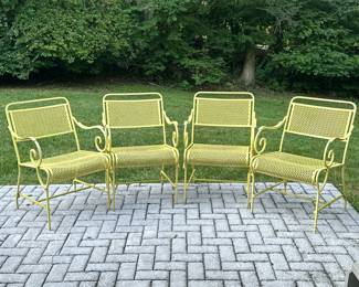 YELLOW AND BLACK PATIO SET | Includes 4 yellow aluminum chairs and large round fiberglass table with yellow aluminum legs connected by x-stretcher Table dimensions: H. 27in Dia. 53.5. - l. 22 x w. 22 x h. 32 in