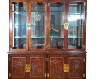 DREXEL HERITAGE CHINESE STYLE CABINET | Long carved wood panel depicting life scenes atop 4 glass door cabinet with three glass shelves and 4 dimmable lights and inlaid 4 door lower cabinets depicting more life wood carved life scenes, each cabinet with padded silverware drawer and 2 shelves. - l. 71 x w. 16 x h. 84 in