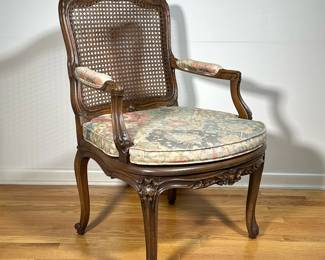 FRENCH CARVED ARM CHAIR | Cane seat and backrest carved decorations. - l. 26 x w. 24 x h. 36 in