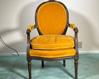 VINTAGE FRENCH STYLE ARMCHAIR | With orange/brown upholstery and cushion. Ornately carved wood. - l. 24 x w. 22.5 x h. 35 in