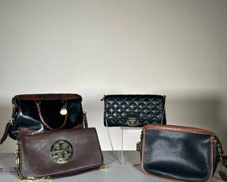 (4PC) SET OF LEATHER HANDBAGS | Four handbags including a small black Calvin Klein shoulder bag, a Tory Burch brown Flap shoulder bag, a black/crocodile trim Brahmin bag, and a black with brown trim Coach bag. - l. 12 x w. 4.5 x h. 7 in