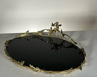 BLACK GLASS TRAY WITH ORNATE RIM | Shiny glass tray with ornate golden ring and cherub. - l. 17 x w. 13 in