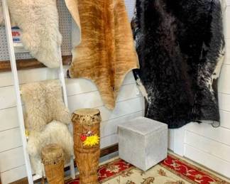 Cowhide & Sheepskin Rugs.  Cowhide ottomans & pillows.  Hand Carved Bongo drums