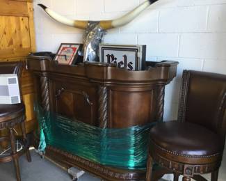 Bar and 2 swivel chairs, cow skull and bar signs 