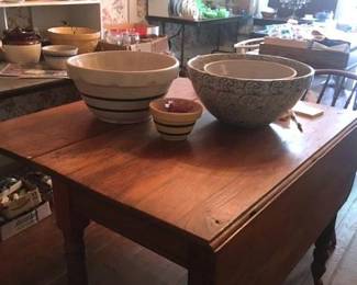 Antique drop leaf table, stoneware, and very full tables