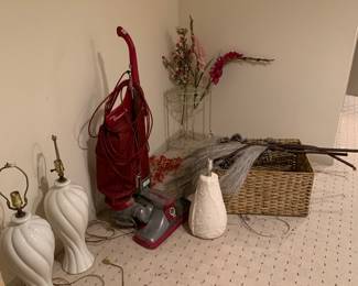 Whole house has lots of lamps, baskets, flowers, accent tables.