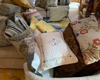 Dozens of throw pillows, most $2 each.