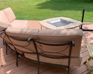 Outdoor padded seating and table.