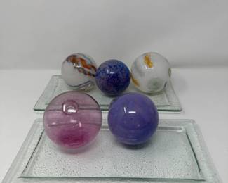 Five Blown Glass Orbs on Glass Trays
