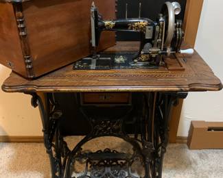 Absolutely gorgeous treadle sewing machine. Intricately inlayed cabinet. Truly a work of art. 