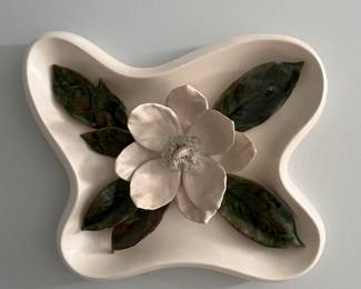 Nice piece of pottery hanging on the wall.  Look at the detail of the magnolia bloom.