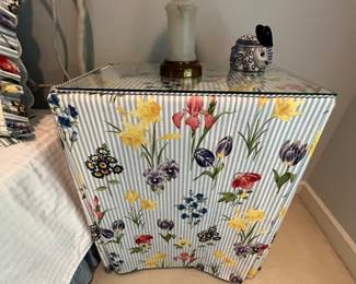 This is a sewing machine disguised as an end table.  I am certain this covering was custom made for it, but what a great idea!  Keep your sewing thread, needles, sewing box out of site, along with the machine!  Use when you need it!