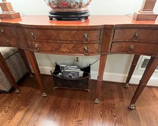 The oh so elegant Maitland Smith six drawer console table.  Brass feet make this piece truly stand out.  Look at the herringbone design of the wood on the drawer fronts.