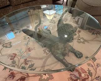 Thick beveled glass on top of a most curious, yet unique base.  You will have much to talk about with this in your home.