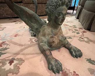 Almost sphinx-like in appearance, but with wings, and lion feet.  It also resembles an old mythical figurehead that adorned the front of "pirate ships."  See what I mean about conversation?  It is endless. 